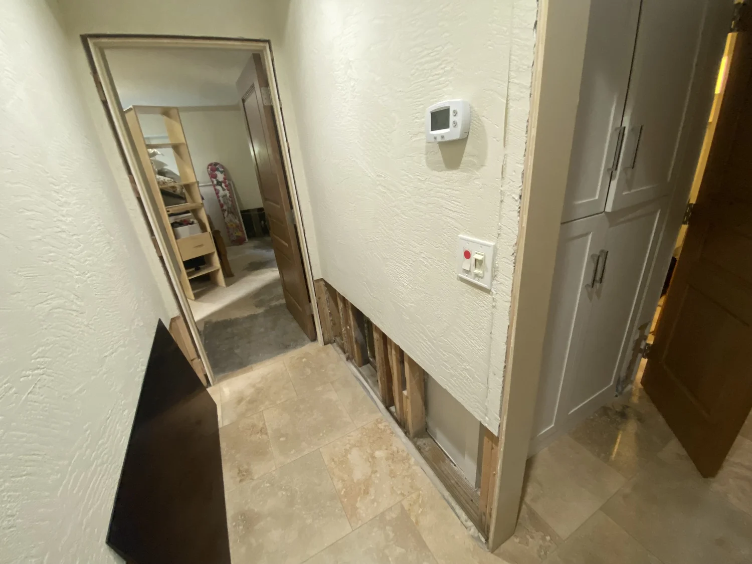 Hallway drywall and stucco cut-out in progress